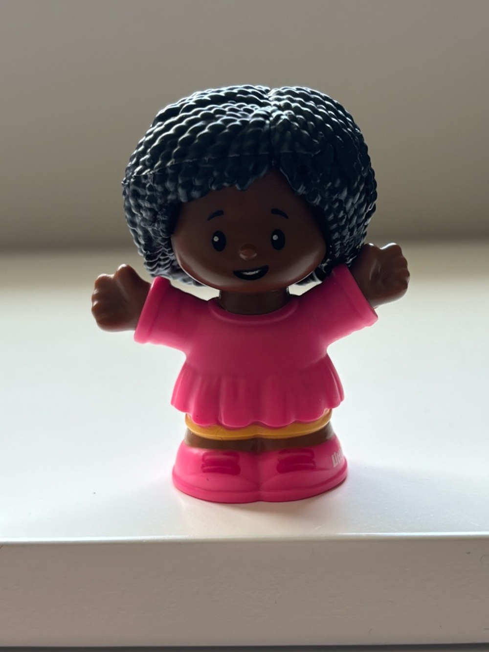 Little people girl in a pink dress